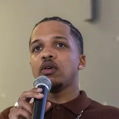 Holder, micro en main, lors d'une prise de parole de l'association